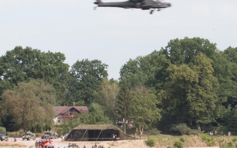 Twin AH-64 Apache helicopter zoom over a newly constructed bridge over the Vistula River near Torun, Poland, on Wednesday, June 8, 2016. A combined group of British and German soldiers conducted the hasty bridge assembly as part of the Anakonda multinational training event currently underway in Poland.