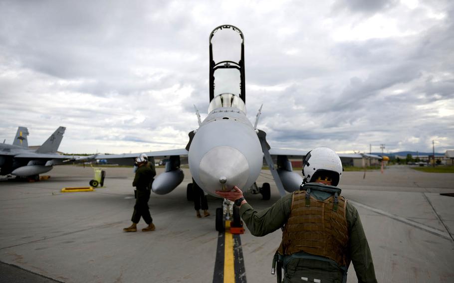 A Marine Corps F-18 Hornet pilot assigned to the Marine All-Weather Fighter Attack Squadron 242 at Marine Corps Air Station Iwakuni, Japan, conducts a pre-flight inspection, Tuesday, June 7, 2016, at Eielson Air Force Base, Alaska.