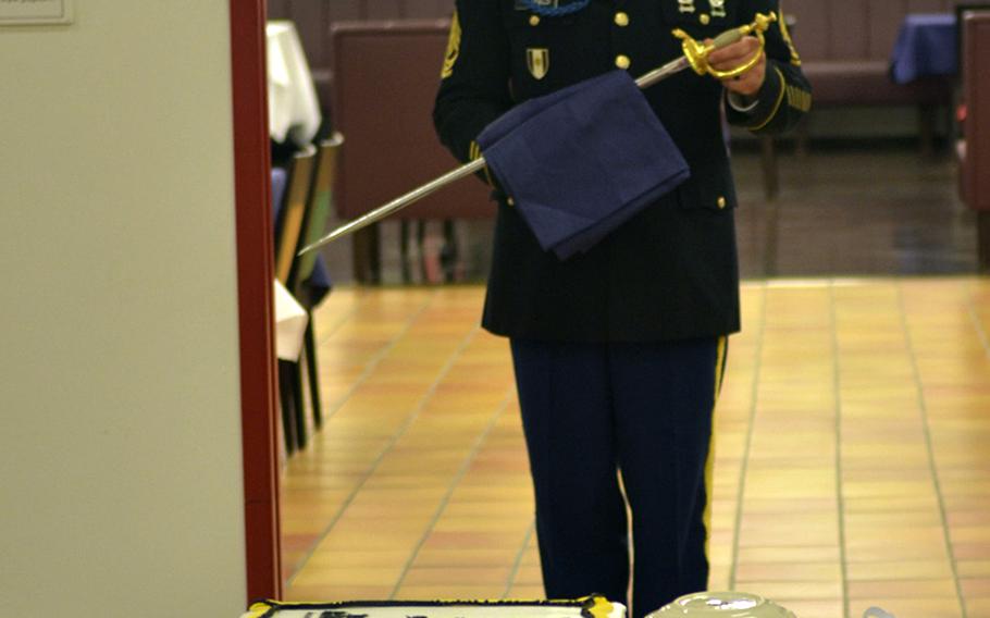 First Sgt. Shaun Canfield, senior enlisted soldier with Intelligence and Support Company, Headquarters and Headquarters Battalion, U.S. Army Europe, holds a saber prior to a ceremony commemorating the Army's 241st birthday June 14, 2016, at Clay Kaserne in Wiesbaden, Germany. The saber was used to cut a specially prepared cake marking the occasion.