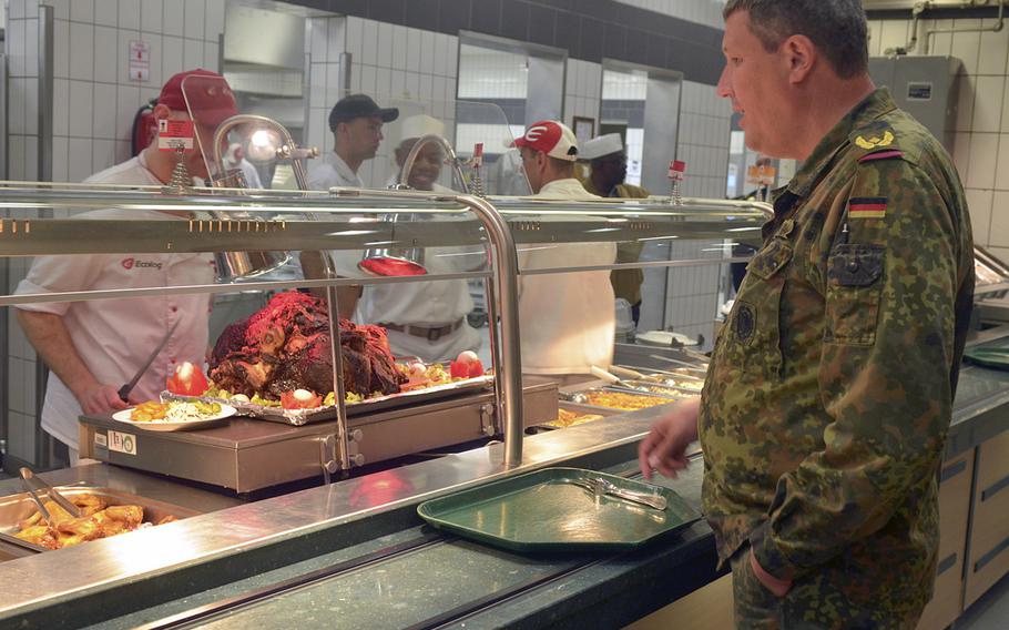 German army Brig. Gen. Markus Laubenthal, chief of staff of U.S. Army Europe, waits for his food in line at the Strong Europe dining facility in Wiesbaden, Germany, June 14, 2016. The dining facility marked June 14, the 241st anniversary of the creation of the U.S. Army, with a brief ceremony.