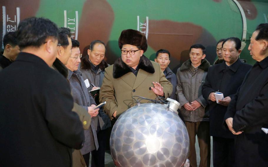 North Korean leader Kim Jong Un poses with what some experts say is a possible nuclear warhead mockup in this undated photo released by the Korean Central News Agency on March 9, 2016.