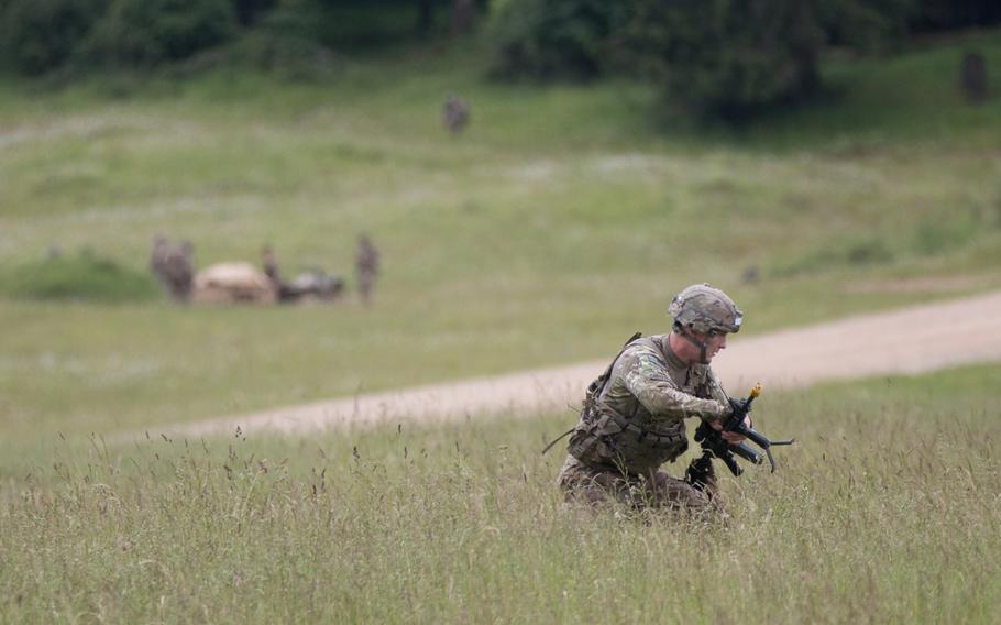 An 82nd Airborne Division soldier scurries off the drop zone to make room for other soldiers soon to be parachuting onto the Hohenfels training ground on Wednesday, June 15, 2016. The 82nd, along with soldiers from Poland, the United Kingdom and France were participating in the second phase of the multinational training exercise Swift Response 16 began.