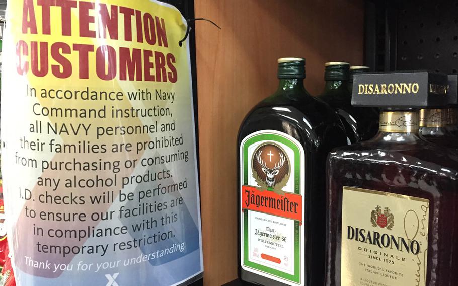 A sign seen Thursday, June 16, 2016, at an Army and Air Force Exchange Service shop at Yokota Air Base, Japan, says "all Navy personnel and their families are prohibited from purchasing or consuming any alcohol products."