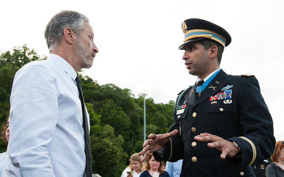Comedian and activist Jon Stewart talks with Medal of Honor recipient retired Army Capt. Florent Groberg Wednesday evening at the U.S. Military Academy at West Point, N.Y. after the opening ceremonies of the Warrior Games.