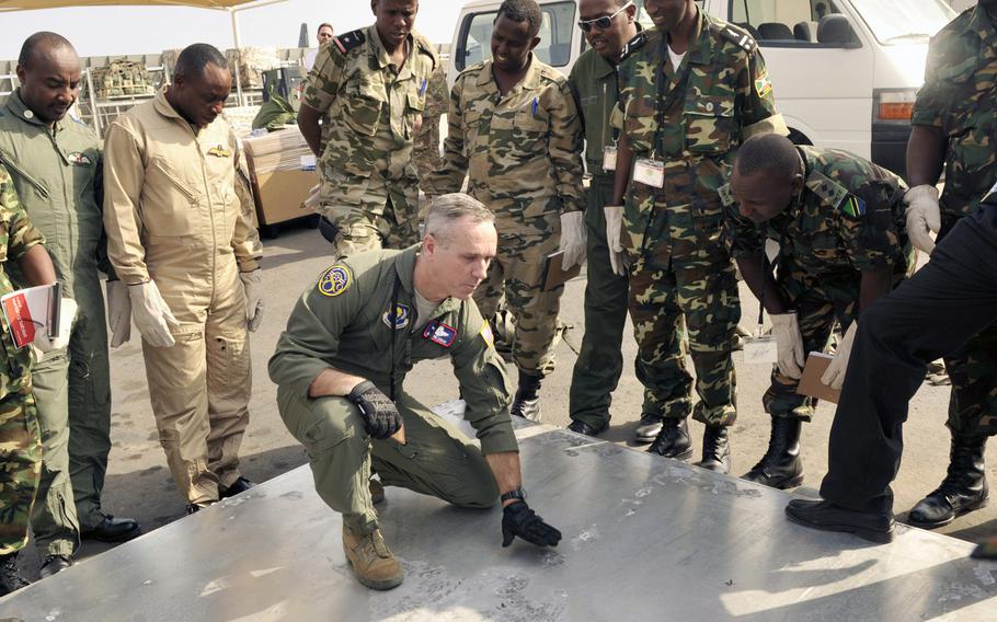 U.S. Air Force Senior Master Sgt. Phillip Leonard, U.S. Air Forces Europe and Air Forces Africa loadmaster adviser, discusses cargo pallet inspection procedures with East Africa air forces members at Djibouti Air Base, Feb. 10, 2015. More than 50 airmen from Europe and the U.S. are preparing to train with their counterparts from three East African countries as part of the first-ever African Partnership Flight in Kenya, which begins Monday, 20 June, 2016.