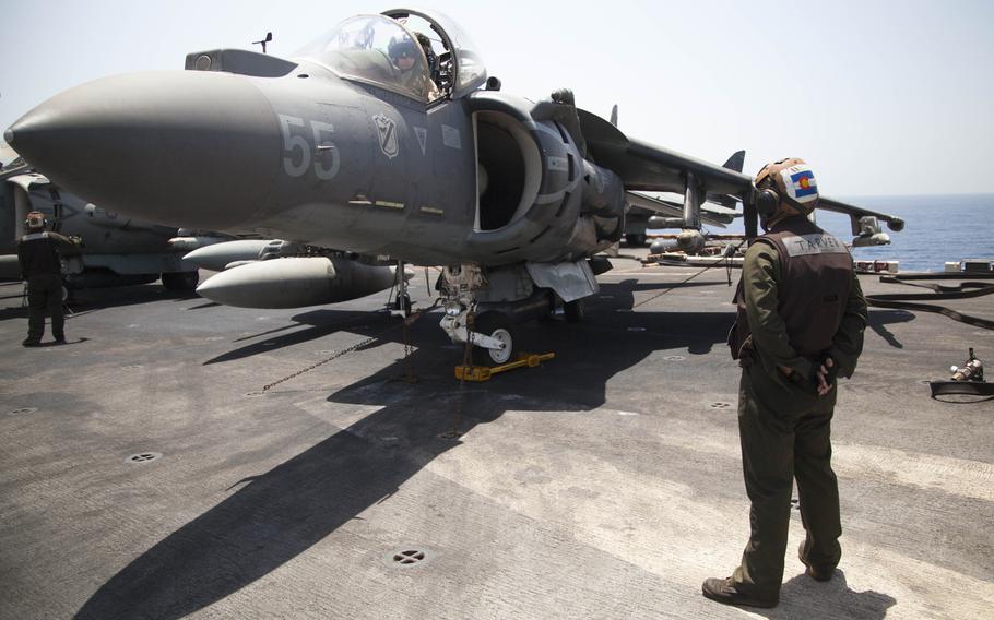 Lance Cpl. Blake Tarver, a plane captain for the 13th Marine Expeditionary Unit embarked on the amphibious assault ship USS Boxer, prepares an AV-8BII Harrier prior to conducting the first aircraft sorties launched from the ship against the Islamic State in Iraq and Syria on Thursday, June 16, 2016.