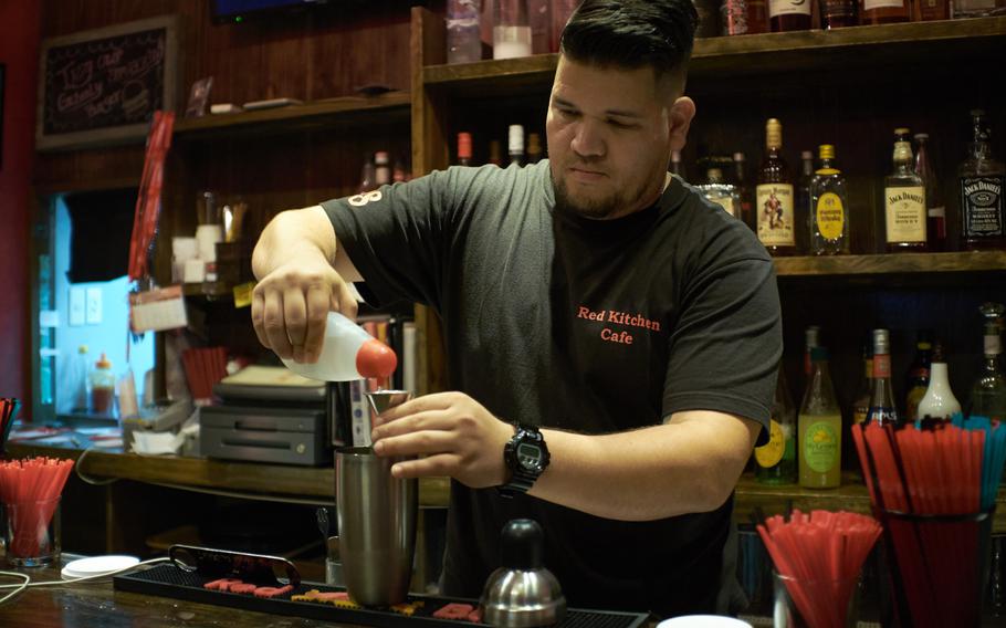 Rodrigo Watanabe mixes a non-alcoholic drink for a military customer at the Red Kitchen and Cafe June 17, 2016 in Okinawa City, Okinawa. Watanabe, who manages both the popular bar and grill and another club in the area, was forced to lay off 10 employees between the two establishments because of the liberty and alcohol sales restrictions on military personnel on the island. He hopes to rehire all of them once the restriction period is lifted.