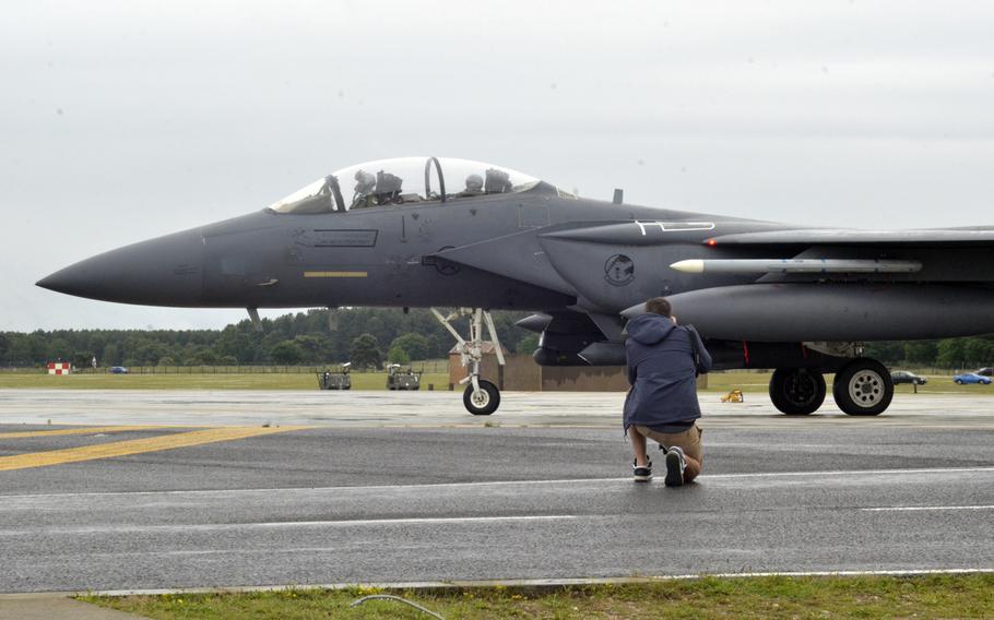 Photographer Matt Pullen documents an F-15E Strike Eagle of the 493rd Fighter Squadron during an Aviation Enthusiasts tour at RAF Lakenheath, Wednesday, June 22, 2016.