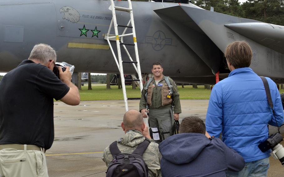 Air Force Maj. Dan "Rosco" Wittmer poses for aviation enthusiasts after completing a mission during a tour at RAF Lakenheath, Wednesday, June 22, 2016. The base allowed amateur and professional photographers a rare chance to get up close and personal with Air Force jets and personnel.