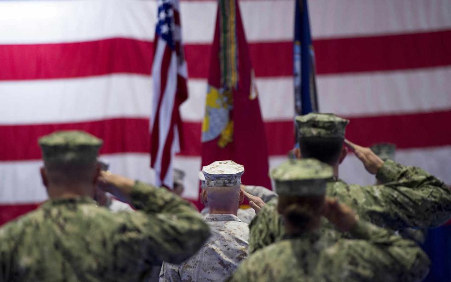 The 5th Marine Expeditionary Brigade staff salutes the flag during the  National Anthem at the 5th MEB change-of-command ceremony, Thursday, June 23, 2016.  

Chris Church/Stars and Stripes