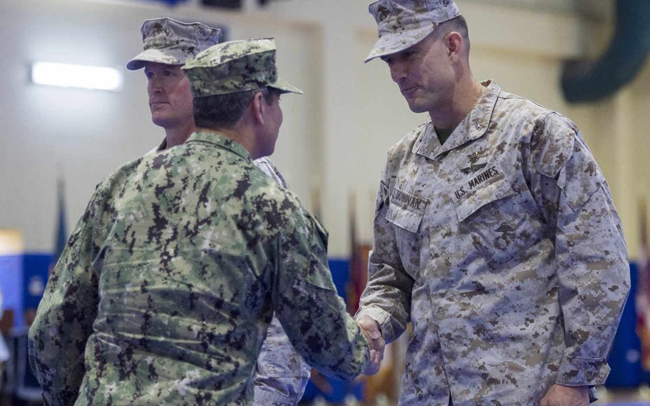 Vice Adm. Kevin M. Donegan, commander of U.S. Naval Forces Central Command, shakes hands with incoming 5th Marine Expeditionary Brigade commander Brig. Gen. Francis L. Donovan's during a change-of-command ceremony, Thursday, June 23, 2016.  

Chris Church/Stars and Stripes
