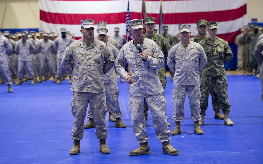 Outgoing 5th Marine Expeditionary Brigade commander Maj. Gen. Carl E. Mundy takes a few moments to single out some Marines and sailors in the command during a change-of-command ceremony, Thursday, June 23, 2016.  

Chris Church/Stars and Stripes