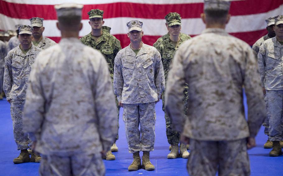 Marines and sailors of the staff and units of the 5th Marine Expeditionary stand at attention in front of their outgoing and incoming commanders, Maj. Gen. Carl E. Mundy III and Brig. Gen. Francis L. Donovan, at the end of a change-of-command ceremony, Thursday, June 23, 2016.  

Chris Church/Stars and Stripes