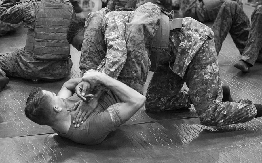 Lance Cpl. Matthew Russo applies the arm bar against his opponent during Marine Corps Martial Arts Program training onboard the amphibious assault ship USS Boxer June 17, 2016.