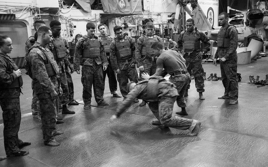 Sgt. David Lam demonstrates and arm bar takedown to Marine Corps Martial Arts Program students during training onboard the amphibious assault ship USS Boxer June 17, 2016.