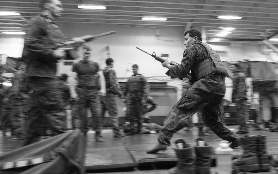 Marines execute weapons techniques during Marine Corps Martial Arts Program training on board the amphibious assault ship USS Boxer June 17, 2016.