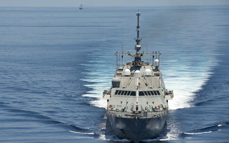 The littoral combat ship USS Fort Worth patrols near the Spratly Islands in the South China Sea in 2015 as the Chinese guided-missile frigate Yancheng transits close behind.