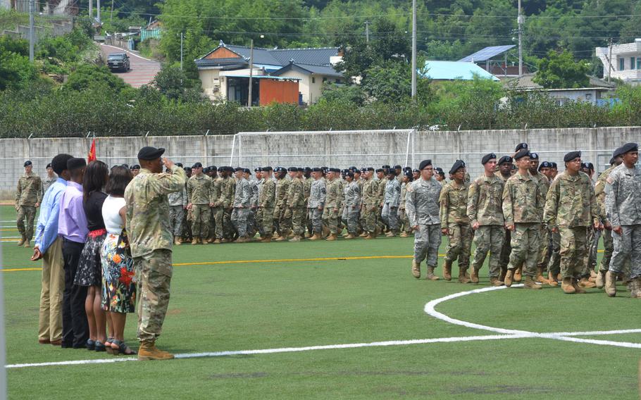 Incoming commander Col. Kenneth K. Williams salutes his units during the pass in review at the end of the 2nd Sustainment Brigade's change-of-command ceremony at Camp Carroll, South Korea, Wednesday July 20, 2016