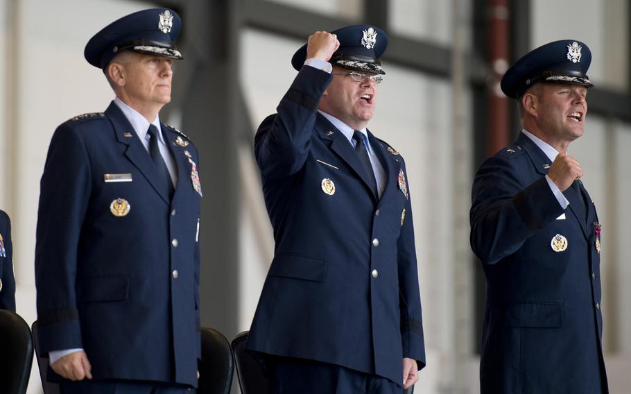 From left, 3rd Air Force Commander Lt. Gen. Timothy Ray sings the Air Force song with Brig. Gen. Jon Thomas, and Brig. Gen. Richard Moore at the end of the 86th Airlift Wing change-of-command ceremony at Ramstein Air Base, Germany, on Wednesday, Aug. 17, 2016. Moore succeeds Thomas as the wing's commander.