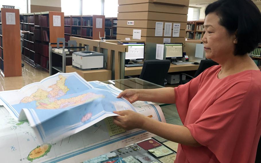 Librarian Kim Youngnam shows maps at the North Korea Information Center in Seoul. The center holds a vast collection of books, magazines, films and other materials from or about the communist country. It's run by South Korea's Unification Ministry, and visitors need permission to enter.