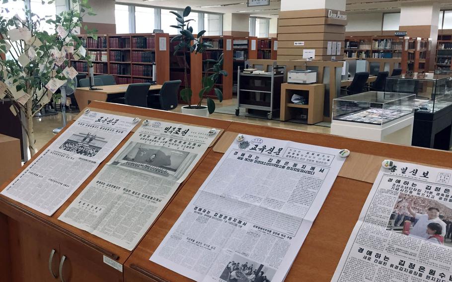 North Korean newspapers are on view near a tree holding messages from South Korean children wishing for unification of the divided peninsula at the North Korea Information Center in Seoul, South Korea.