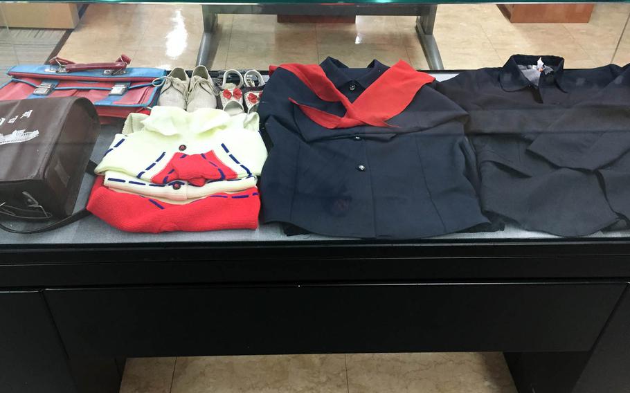 North Korean school uniforms and children's shoes on display at the North Korean Information Center in Seoul, South Korea. The center is run by South Korea's Unification Ministry, and visitors need permission to enter.