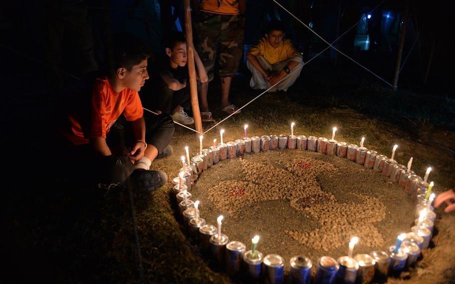 Afghan boys gather around a fire ring to chant a scout song on Sept. 8, 2016. The boys camped out overnight as part of a three-day camporee in Kabul, the first of its kind since the Soviets invaded Afghanistan in 1979.