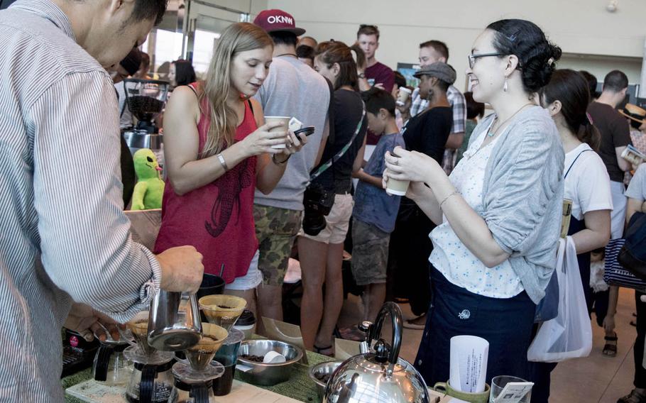 Coffee connoisseurs try a cup of brew from Yamada Coffee Okinawa at the inaugural Okinawa Coffee Festival, Sunday, Oct. 2, 2016.