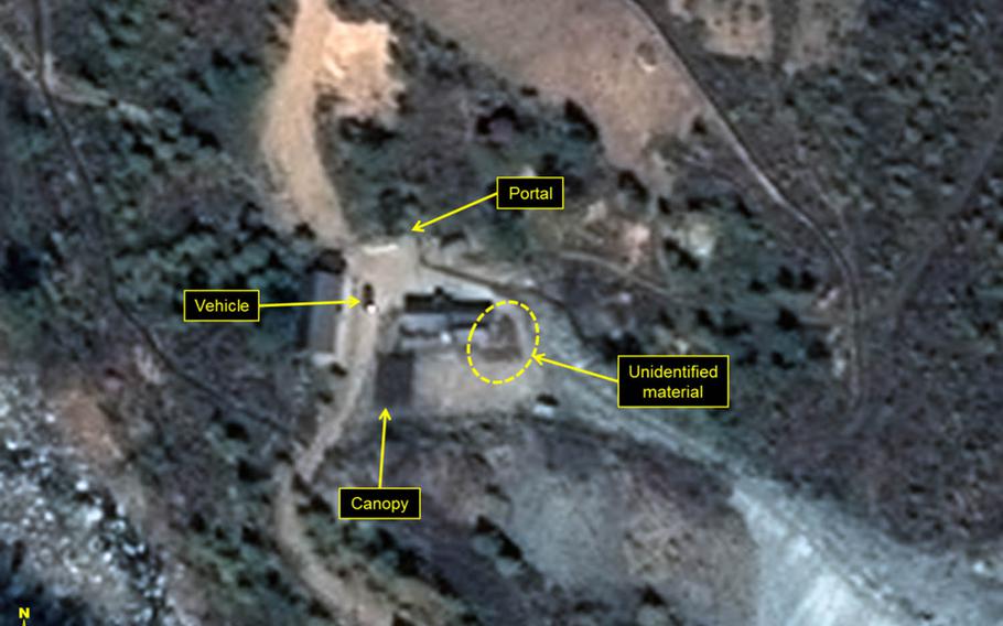 This satellite image provided by Airbus Defense and Space and 38 North shows a large vehicle near the entrance to the north portal at North Korea's underground nuclear-test site, along with unidentified materials around the portal's main building.