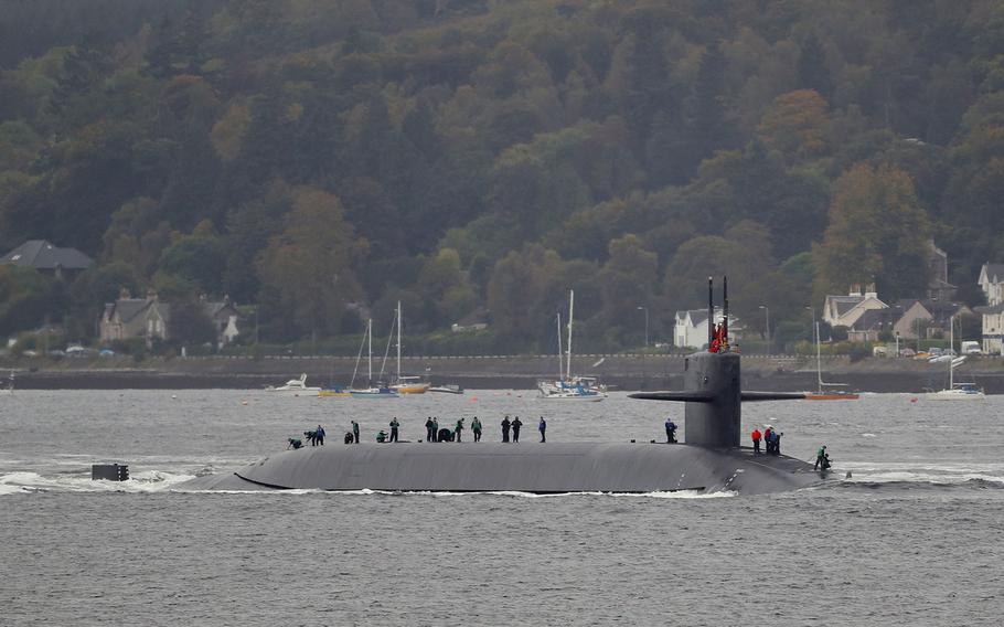 Crewmembers are seen aboard the submarine USS Tennessee as it enters Scotland's Faslane naval base Friday, Oct. 7, 2016.