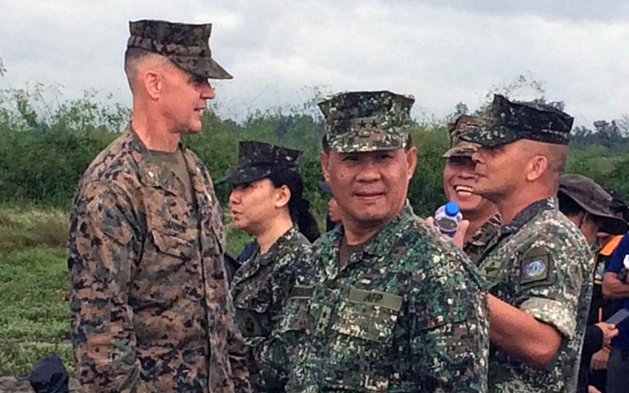 Brig. Gen. John Jansen, commander of the Okinawa-based 3rd Marine Expeditionary Brigade, talks to a group of Philippines military officers following a beach assault on the island of Luzon on Friday, October 07, 2016.