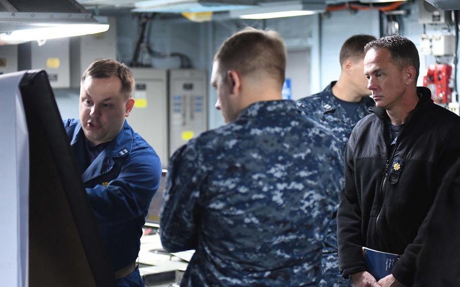 Lt. Donald Todorowski,  N1 contingency manning leader, left, and Lt. Cmdr. Corey Millis, right, an operational planning team leader, strategize during U.S. European Command's computer-assisted exercise, Austere Challenge 17 aboard  the U.S. 6th Fleet command and control ship USS Mount Whitney in the Black Sea, Tuesday, Oct. 11, 2016.
