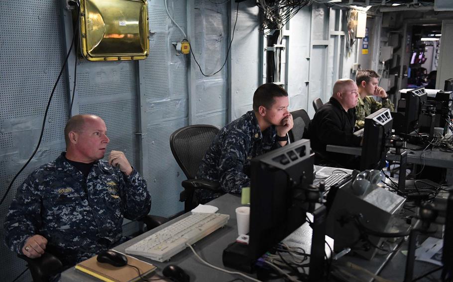Cmdr. Robert Round, a senior Navy meteorology and oceanography officer, works alongside his team during U.S. European Command's computer-assisted exercise, Austere Challenge 17 aboard the USS Mount Whitney in the Black Sea, Tuesday, Oct. 11, 2016.