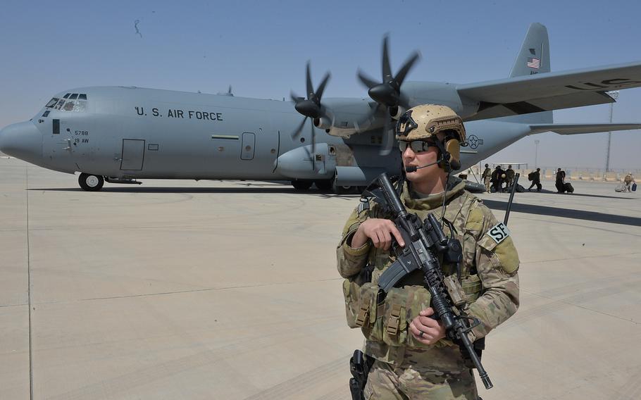Airman 1st Class Jesse Johnson, a member of the U.S. Air Force's Fly-Away Security Team at Bagram Air Field, provides perimeter security for a C-130J Super Hercules on the flight line at Camp Shorab in Afghanistan's volatile Helmand province, on Sept. 23, 2016.