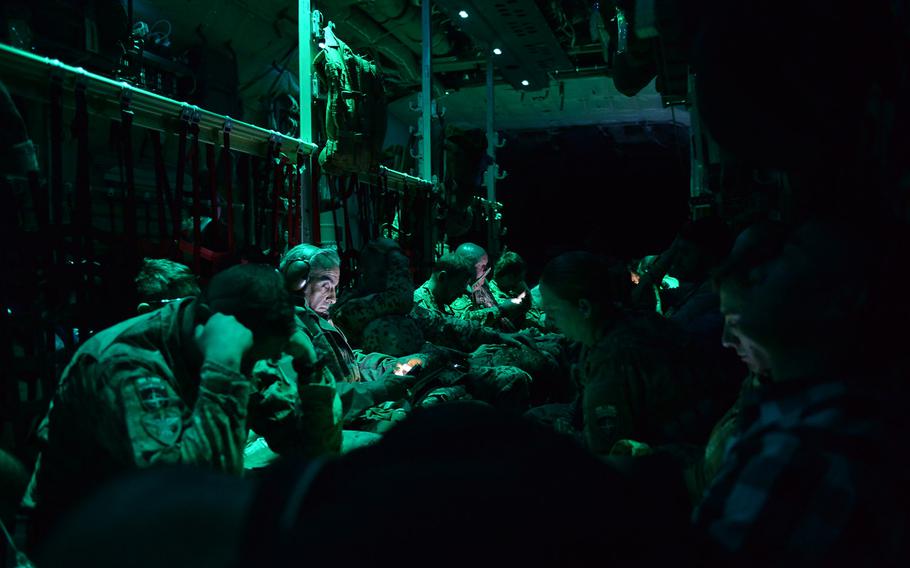 Passengers on a C-130J Super Hercules doze or watch videos on their personal devices during a flight from Mazar-e-Sharif to Kabul International Airport on Sept. 23, 2016.