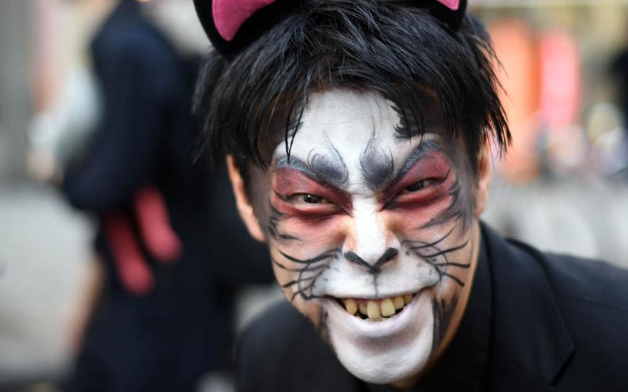 A man hams it up for the camera during the Bakeneko festival, Sunday, Oct. 16, 2016, in Tokyo. The annual Halloween-like festival, whose name roughly translates to "ghost cat with supernatural powers," includes a long and lively parade of costumed revelers, live music and street dancing.