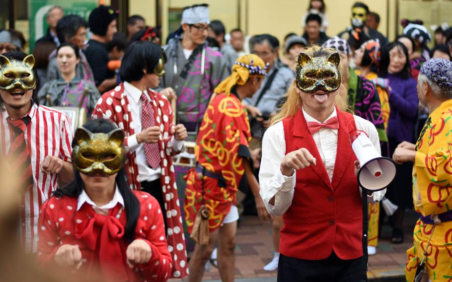 Revelers perform a cat dance during the Bakeneko festival, Sunday, Oct. 16, 2016, in Tokyo. The annual Halloween-like festival, whose name roughly translates to "ghost cat with supernatural powers," includes a long and lively parade of costumed revelers, live music and street dancing.