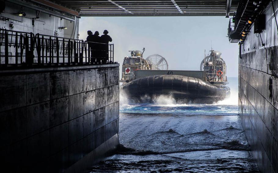 A Navy Landing Craft, Air Cushion from amphibious transport dock USS San Diego enters the well dock of Australia's HMAS Canberra off the coast of Hawaii during Rim of the Pacific drills in July. A new report suggests that expanding amphibious exercises between America and Australia is one of several ways to strengthen the alliance and enhance the U.S. policy of rebalancing to the Pacific.