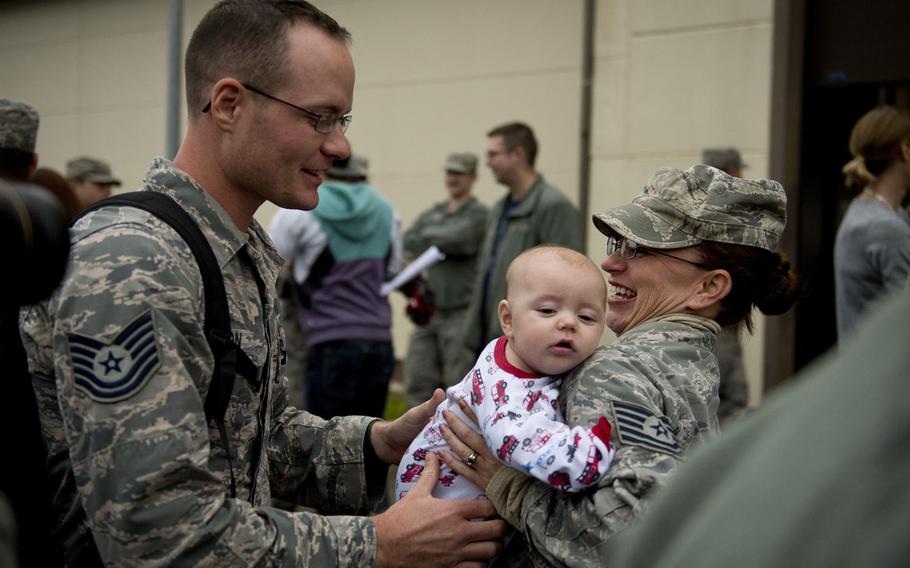 Tech. Sgt. Brian Solomon, left, meets his new son for the first time with his wife, Tech. Sgt. Tiffany Solomon, at Spangdahlem Air Base, Germany, on Thursday, Oct. 20, 2016. Solomon just finished a six-month deployment to Southwest Asia with the 606th Aircraft Control Squadron.