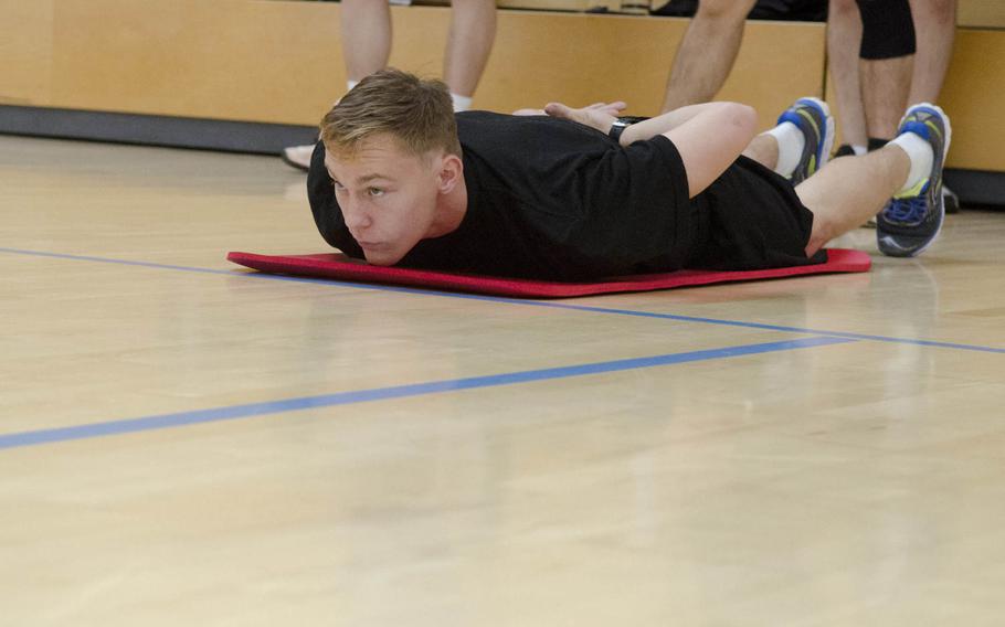 Staff Sgt. Justin May, with 2nd Military Intelligence Battalion, 66th Military Intelligence Brigade, lies in the starting position before the 110-meter shuttle sprint event of the German Armed Forces Badge for Military Proficiency testing, Tuesday, Oct. 18, 2016, at Clay Kaserne in Wiesbaden, Germany. May earned a gold badge, meaning he met the highest standard in all six events of the testing.