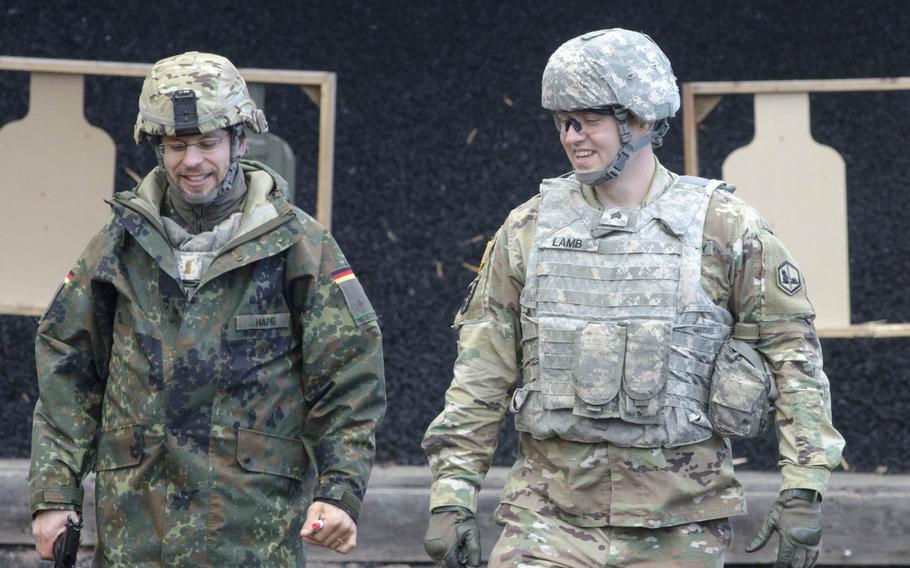 German Army Lt. Christian Hapke, left, of the Landeskommando Bayern, and U.S. Army Sgt. James Lamb share a laugh after Lamb successfully completed the pistol marksmanship event of the German Armed Forces Badge for Military Proficiency testing, Wednesday, Oct. 19, 2016, in Wackernheim, Germany. To pass the event, participants had to successfully hit three of five targets at 25 meters.