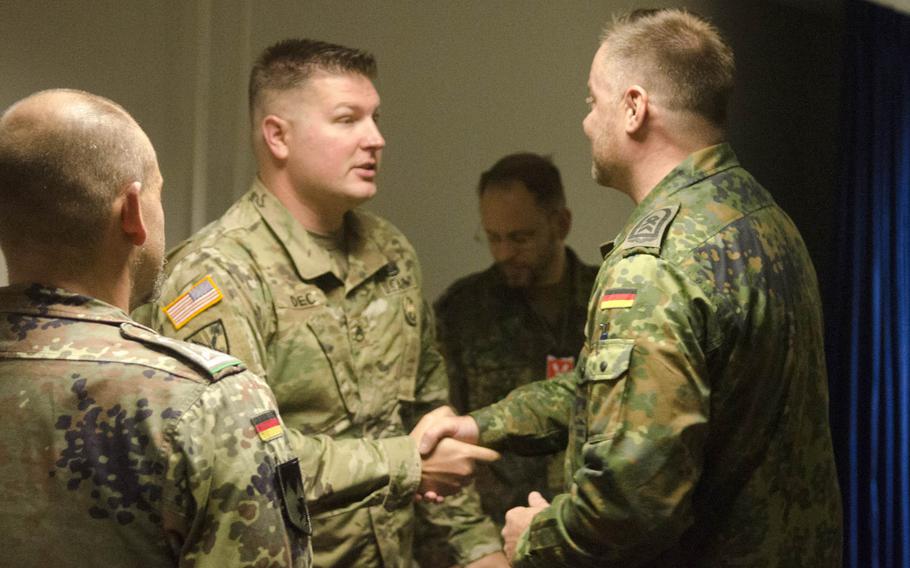 German Army Sgt. Maj. Juergen Schulz, right, of the Landeskommando Bayern, congratulates U.S. Army Staff Sgt. Daniel Dec on earning the German Armed Forces Badge for Military Proficiency Thursday, Oct. 20, 2016, at Clay Kaserne in Wiesbaden, Germany. Dec was one of 15 soldiers from the 66th Military Intelligence Brigade to earn the badge, which can be displayed on dress uniforms.
