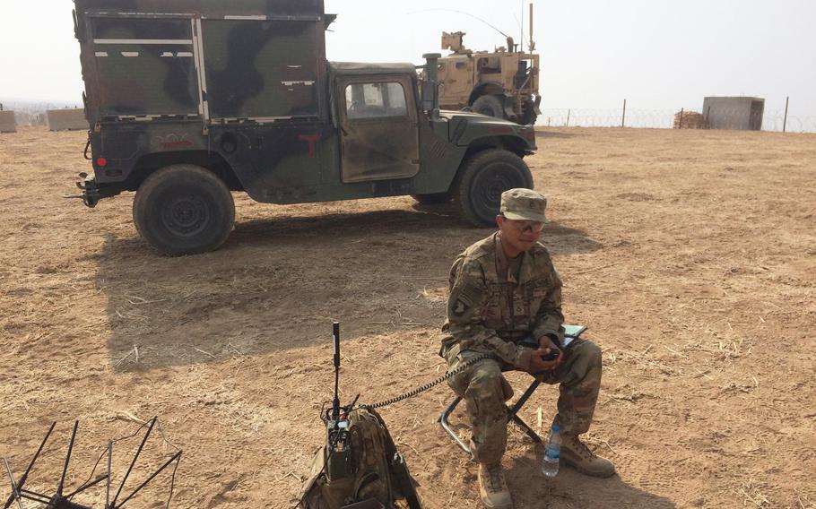 Pfc. Juan Flores, 26, of Ontario, Calif., mans a radio on a base half way between Irbil, capital of Iraqi Kurdistan and the besieged city of Mosul, Iraq, on Tuesday, Oct. 25, 2016.