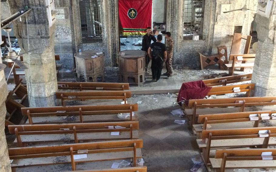 Iraqi troops inside a church in Bartella, a Christian village liberated from the Islamic State on Saturday, Oct. 22, 2016. 