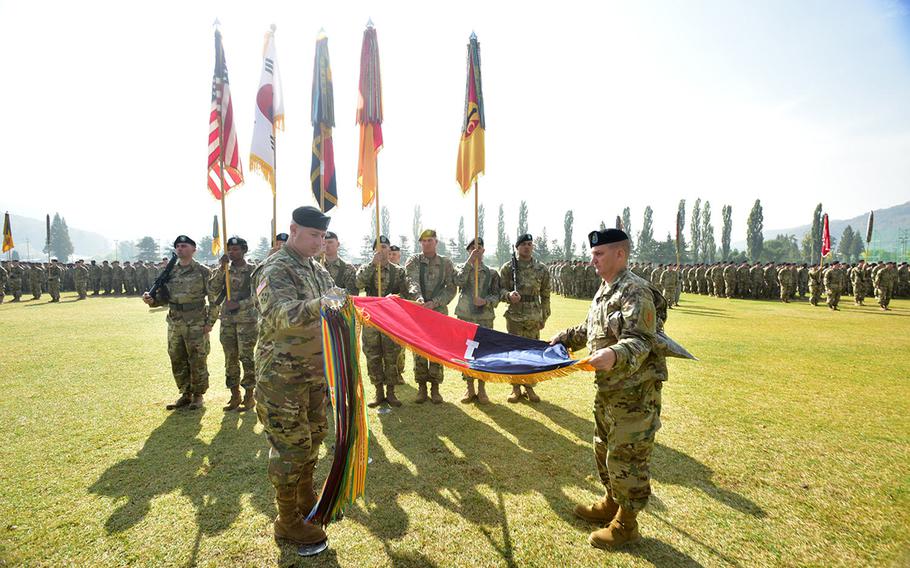 Col. Timothy Hayden, left, 1st Armored Brigade Combat Team, 1st Infantry Division, and Command Sgt. Maj. Dale Sump, 1st ABCT, 1st ID command sergeant major, uncase the brigade's colors during a Transfer of Authority ceremony held at Camp Casey on Thursday, Oct. 27, 2016. 1st ABCT, 1st ID is assuming the rotational mission conducted by 1st ABCT, 1st Cavlary Division for the last nine-months.