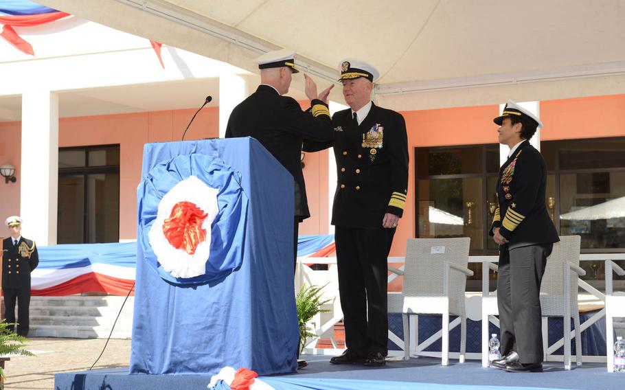 Outgoing 6th Fleet commander Vice Adm. James Foggo salutes incoming leader Vice Adm. Christopher W. Grady at a change of command ceremony Friday at the fleet's headquarters in Naples, Italy. Looking on is Adm. Michelle Howard, the Navy's top officer in Europe.