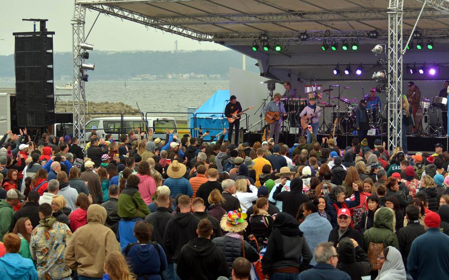 The crowd fills Berkey Field on a chilly Sunday as Jimmy Buffett and the Coral Reefer Band perform for servicemembers at Yokosuka Naval Base, Japan, Oct. 30, 2016.