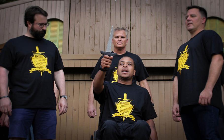 Air Force veteran Marcus Murray, front center, performs a selection from a Shakespeare play at Louisville's Central Park in July. He is flanked by fellow veterans Brian Easley, Shakespeare With Veterans co-founder Fred Johnson, back center, and Rob Givens.