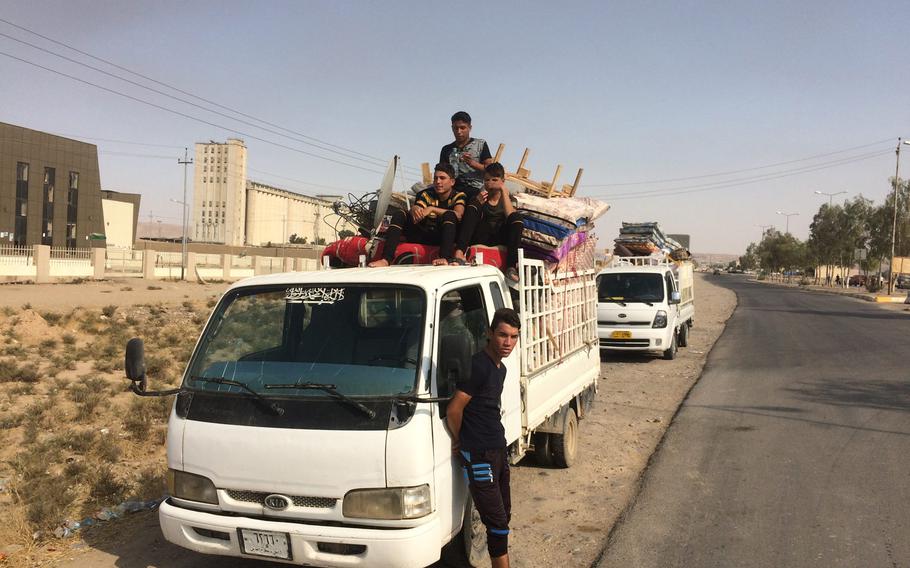 Overloaded trucks carrying Iraqi families and household goods back up at Makhmour on their way home to liberated villages south of Mosul on Saturday Oct. 29, 2016.