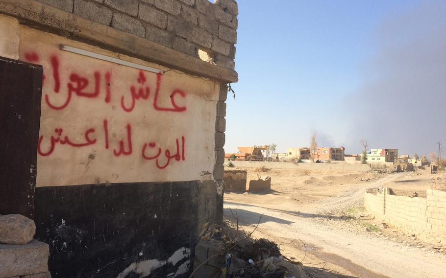 Villages once controlled by the Islamic State on the east side of the Tigris River are almost completely abandoned except for the occasional looter scavenging for items the militants left behind. Some buildings have been completely destroyed by the fighting. Others are riddled with bullet-holes and this one, seen on Saturday, Oct. 29, 2016, has Arabic graffiti scrawled on it that reads: ''Long live Iraq, Death to the Islamic State.''
